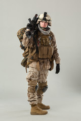 Soldier in camouflage holding rifle