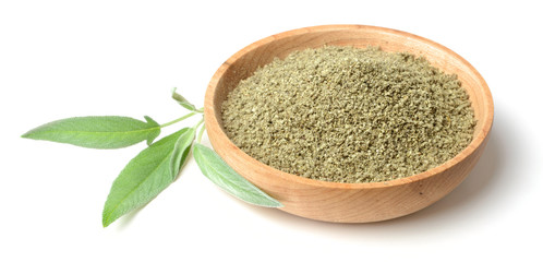 rubbed sage in the wooden plate, isolated on white