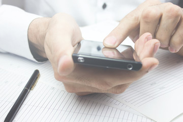 Business image - a businessman using a smartphone
