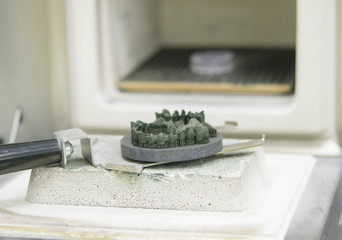 Object printed on metal 3d printer near the kiln for sintering after heat treatment synterization...