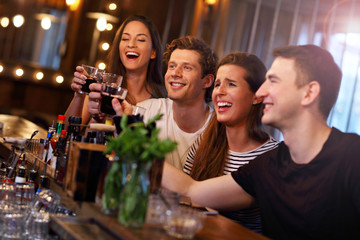 Group Of Friends Enjoying Meal In Restaurant