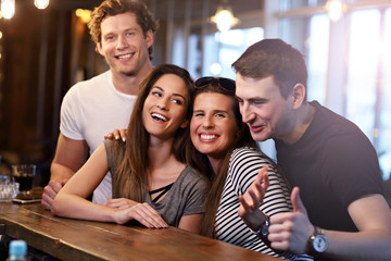 Group Of Friends Enjoying Meal In Restaurant