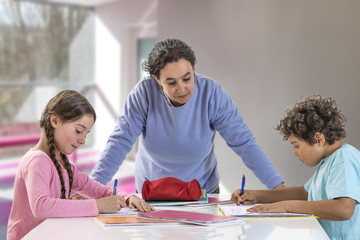 Serious mother helping their child to do homework at home