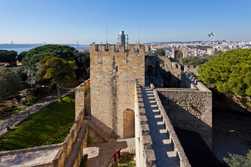 Fototapeta na wymiar Lisbon, Portugal - February 1, 2013: Castelo de Sao Jorge aka Saint George Castle. Barbican structure on the keep entrance and the Ulysses Tower.