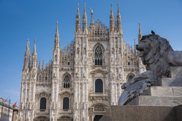 Fototapeta na wymiar An architecture of Milan Cathedral with a lion statue on momument, the famous landmark, Duomo di Milano, Milan Italy