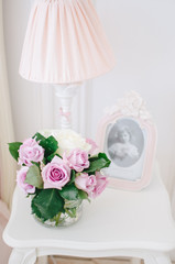 Beautiful roses on a table in a vase, flowers in the room, home cosiness