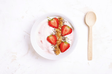 Acai banana strawberry smoothie bowl with chia seeds, fruits, berries, granola cereals, mixed nuts. Healthy vegan diet food. Raw ingredients breakfast, white table top background, copy space, top view