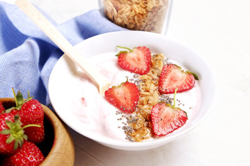 Acai banana strawberry smoothie bowl with chia seeds, fruits, berries, granola cereals, mixed nuts. Healthy vegan diet food. Raw ingredients breakfast, white table top background, copy space, top view