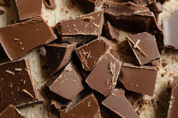 Chocolate Pieces Broken and Scattered on Wooden Board