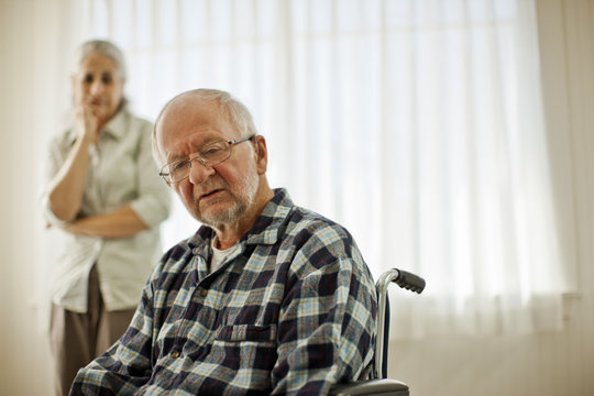 Unhappy senior man sitting in a wheelchair.