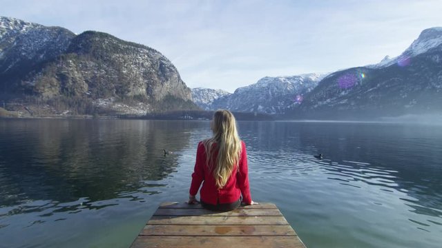 Woman relaxing on a pontoon at Hallstatt Lake