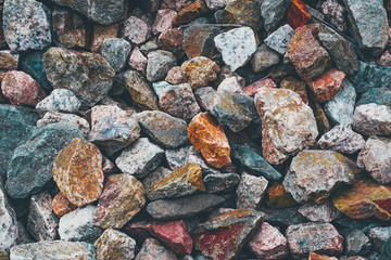 Stones texture background. Red blue grey orange yellow rocks