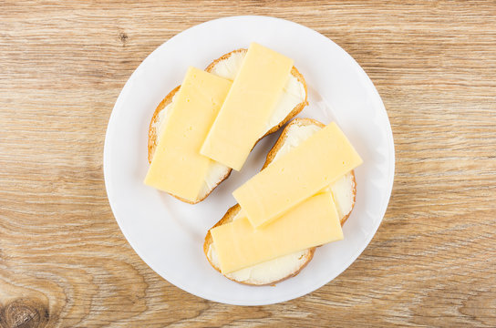 Sandwiches With Butter And Cheese In White Plate On Table