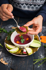Raw vegan beetroot soup in bowl with avocado, mushrooms, tomatoes, walnuts, cabbage. Usually served with vegetable salad, bread for lunch. Traditional Russian dip borscht. Vegetarian healthy food