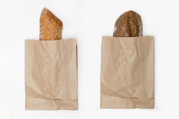 a loaf of black and white bread in a paper bag isolated on white background