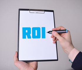A businessman shows an inscription:ROI