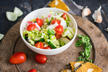 Fresh vegetables salad in bowl. Tomatoes, cucumbers, lettuce	