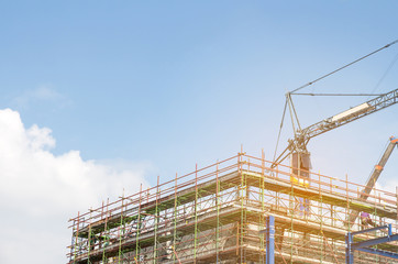 Lots of tower Construction site with cranes and building with blue sky background,scaffolding for construction factory