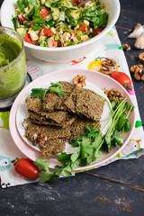 Crispy flax seeds bread dried with spices and herbs. With fresh green onion. Raw, vegan, vegetarian healthy food concept.
