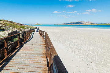 wooden boardwalk in La Pelosa