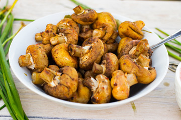 Roasted grilled mushrooms on coals brazier. Fried mushrooms. Dinner or lunch for outdoor picnic. Raw vegan vegetarian healthy food.