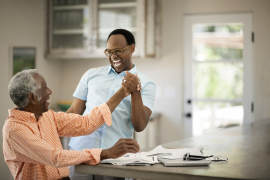 Father and son laughing together at home