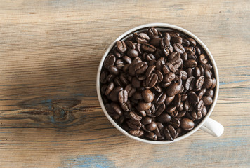 A cup full of coffee beans.