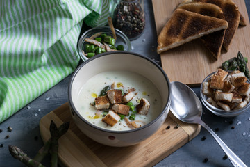Delicious asparagus soup with bacon, fried asparagus and homemade pastries