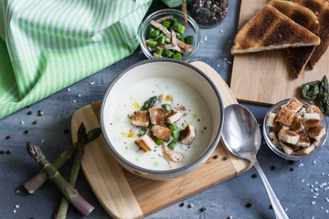 Delicious asparagus soup with bacon, fried asparagus and homemade pastries