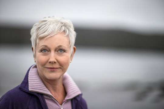 Portrait of an attractive mature woman at the beach in winter.