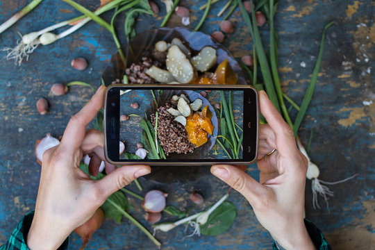 Phone photography of food for social networks.  Smartphone photo of buckwheat porridge with backed pumpkin and Israeli artichoke. Raw vegan vegetarian healthy food