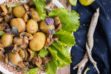 Backed potatoes and roasted mushrooms on salad leaves. Organic farm lunch or dinner. Raw vegan vegetarian healthy food
