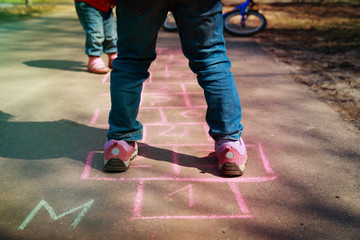 Fototapeta na wymiar little girl play hopscotch on playground