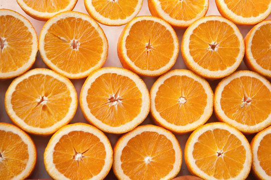Fresh ripe half cut oranges .