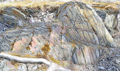 a huge natural stone lies on the ground