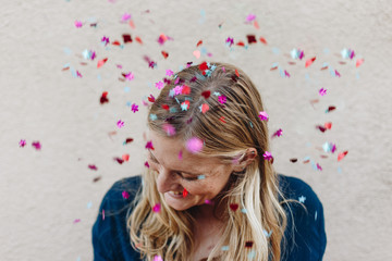 Blonde tossing confetti in celebration