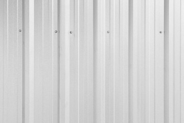 Obraz premium Close-up of a shiny corrugated galvanized metal wall texture background in black and white. Full frame.