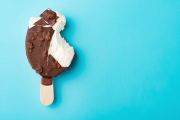chocolate outer ice cream with some bites on a blue background