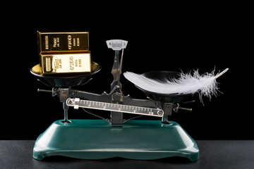 gold bars lighter than a feather on black concept of gold worthless
