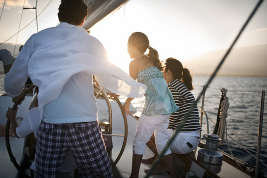 Family sailing at sunset