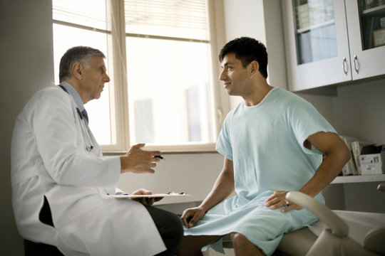 Senior doctor consulting with a patient after a medical exam.