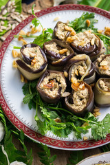 Roasted eggplant rolls with walnuts, garlic, coriander, oil, onion. Traditional Georgian food cold snack. Rolls for dinner or lunch. Raw vegan vegetarian healthy food