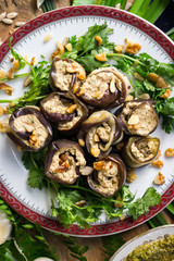 Roasted eggplant rolls with walnuts, garlic, coriander, oil, onion. Traditional Georgian food cold snack. Rolls for dinner or lunch. Raw vegan vegetarian healthy food