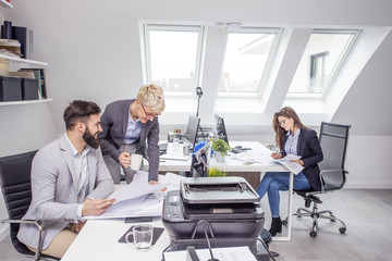 Group of young people working on curent project in office