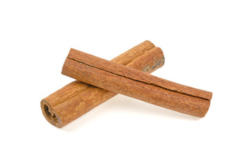 two cinnamon sticks on a white background