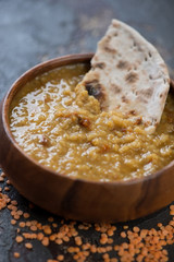 Closeup of masoor dal or thick indian red lentils soup, selective focus, vertical shot