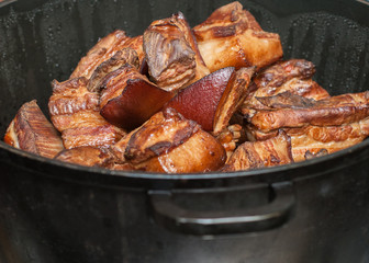 smoked meat and fat in a cauldron