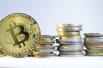 Bitcoin with many coins on white background as in business concept.