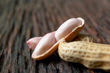 closeup from natural peanut on dark wooden this concept is for agriculture or health.