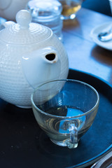 Hot tea with lemon in a glass box with a casual brew. Rest from work